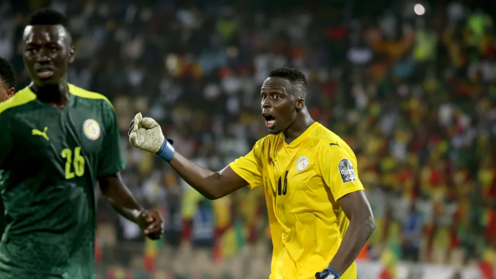 Édouard Mendy, en tenue jaune à droite, donne une consigne avec la sélection sénégalaise.